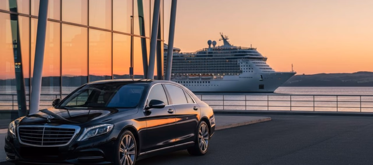 Large cruise ship at port, with a black Mercedes in front of it, suitable for cruise terminal transfer service