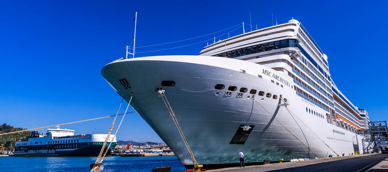 Large cruise ship docked at port, suitable for cruise terminal transfer service