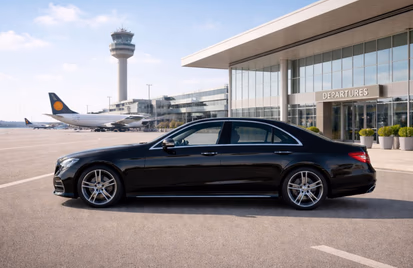 Black executive saloon outside an airport departures terminal
